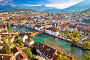 Switzerland Tour: Historic Lucerne buildings reflected in the crystal-clear riverfront