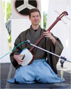 Kyle_Abbott_playing_shamisen_Japanese_Instrument