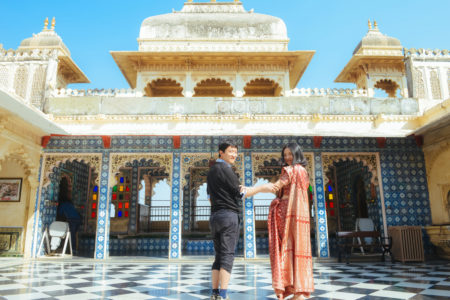 young Asian couple having fun at top floor in City Palace, Udaipur, India