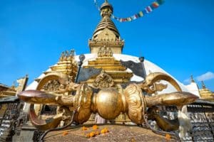 At Swayambhu complex, the first sight on reaching the top of the stairway is the Vajra, a symbolic and ritual tool meaning both a thunderbolt and a diamond. It is an awesome view in Nepal tours and travels.