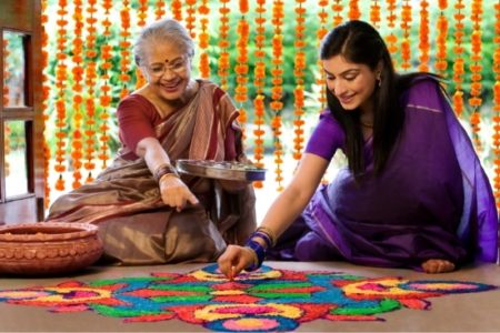 Arranging rangoli to welcome guests and goddess Lakshmi at Diwali. Arranging rangoli to welcome guests and goddess Lakshmi at Diwali.